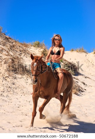 horse riding on the beach. young woman horse riding