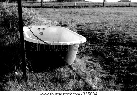 Old cast iron tub in a farmers field.