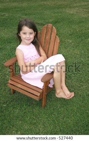 Little girl sitting in a lawn chair