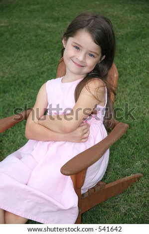 Little girl sitting in a lawn chair
