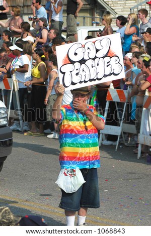 stock-photo-gay-teacher-holding-a-sign-in-a-gay-pride-parade-1068843.jpg