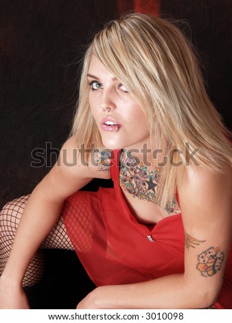 Beautiful blonde model with tattoos in studio
