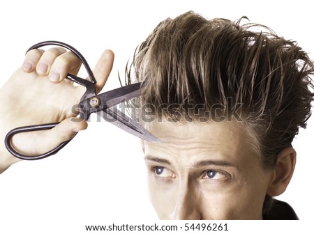Young man cutting his beautiful long hairs