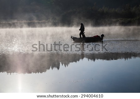 An angler on a quiet lake