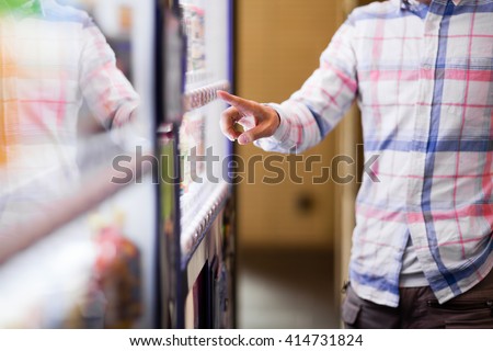 A man standing in front of a vending machine