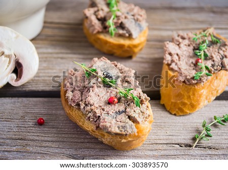 Baked chicken pate with thyme and mushrooms, toast, old wooden