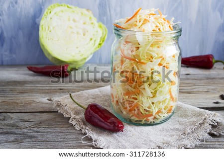 Pickled cabbage with carrots and red hot peppers, selective focus