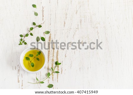 Sprigs of thyme and olive oil on a white Shabby background, space for text