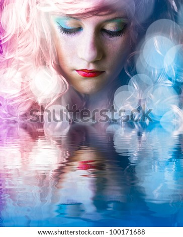 Sweet teen with colored hair, light effects in the water reflection