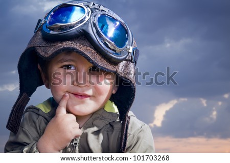 Adorable baby dressed in pilot uniform with funny face