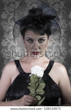 Sad Widow on vintage background, beautiful woman with black veil