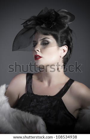 Widow on gray background, beautiful woman with black veil