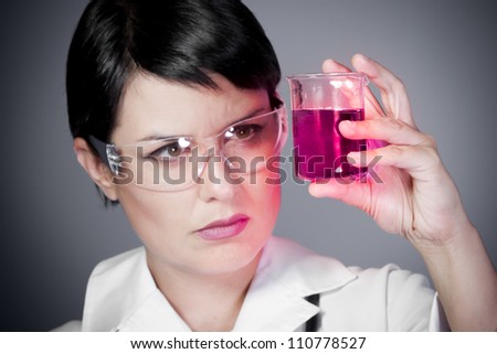 young brunette female doctor checking laboratory samples with protective glasses, career women, research