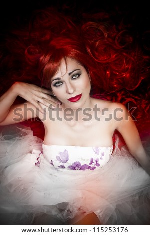 young beautiful redheaded princess dress looking at camera
