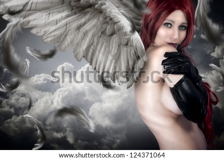 Sensual female angel posing over a cloudy sky with feathers