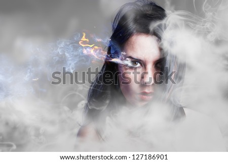 Beautiful anger, girl with burning eye, smoke