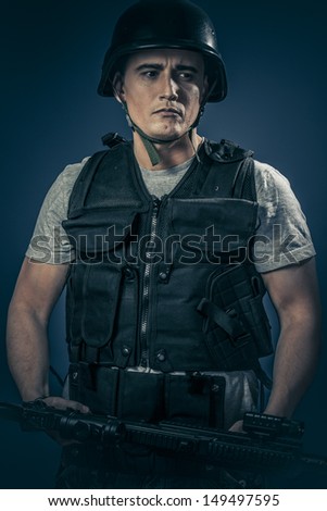Security concept, armed man with machine gun