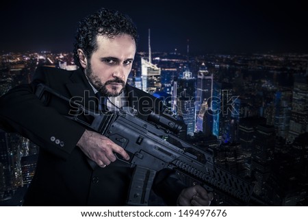 Dangerous business man  concept, armed  with machine gun