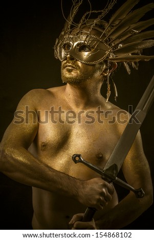 Combative, warrior or ancient god with golden mask and sword greatsword
