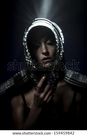Beautiful brunette woman in armor formed by mirrors