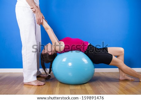 portrait of a young pretty couple, fitness indoor, exercise ball