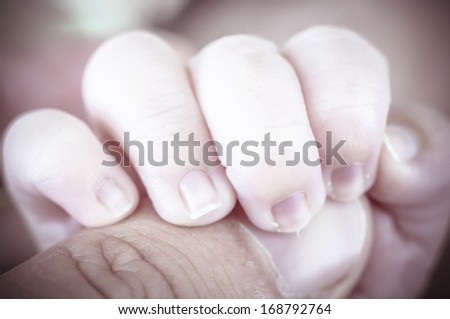 Hand, new born baby curled up sleeping on a blanket, multiple expressions