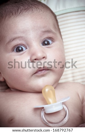 Pacifier, new born baby curled up sleeping on a blanket, multiple expressions