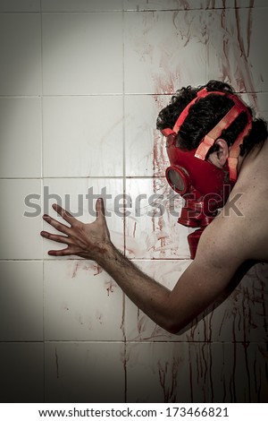 Crime scene, man with blood stains, nude with gas mask