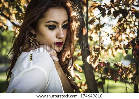 Carefree  cheering woman in spring or summer forest park full of hope and vitality. Mixed race Asian Caucasian female model.