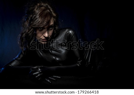 Hot, Sexy brunette in black latex costume, Fashion shot of a woman in black glossy