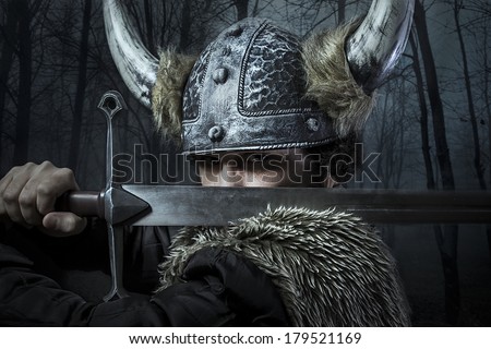 Defense, Viking warrior, male dressed in Barbarian style with sword, bearded