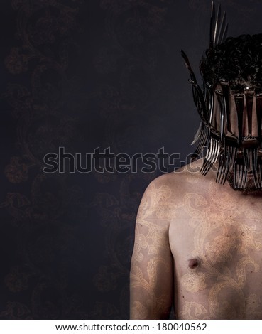 naked man with helmet made of forks
