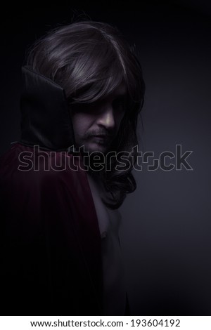 Paranormal, man with long hair and black coat