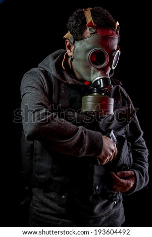 Private detective with bulletproof vest and gas mask