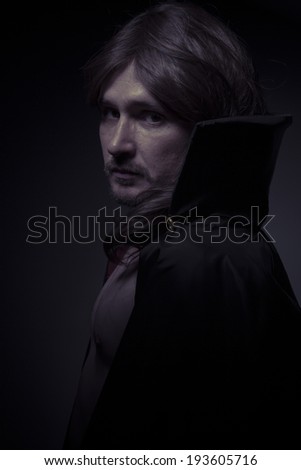 Evil man with long hair and black coat
