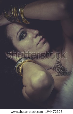 brunette woman with gold and silver jewelry