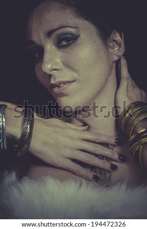 Magic brunette woman with gold and silver jewelry