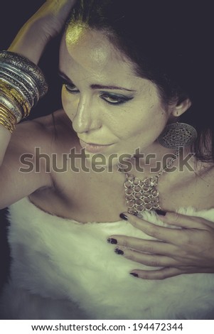 Luxury, brunette woman with gold and silver jewelry