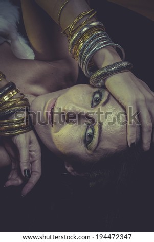 Dark brunette woman with gold and silver jewelry