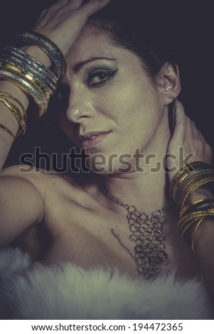 Lady brunette woman with gold and silver jewelry