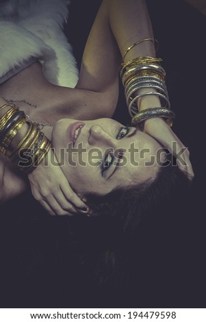 Sexy brunette woman with gold and silver jewelry