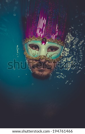 Mask, man immersed in bluewater, concept of depression