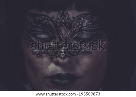 Sad, portrait of woman with black mask thread Venetian