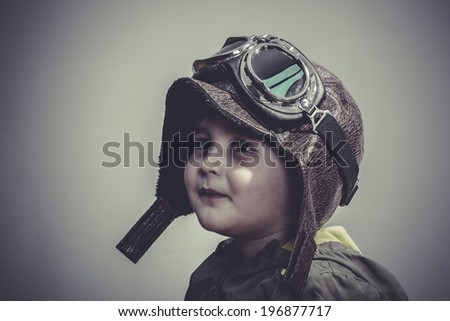 playing, fun and funny child dressed in aviator hat and goggles