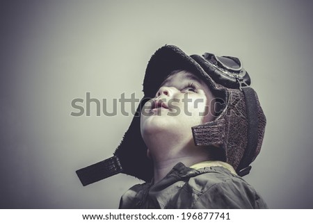 fun and funny child dressed in aviator hat and goggles