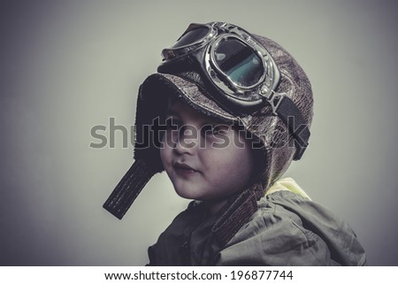 aviation, fun and funny child dressed in aviator hat and goggles