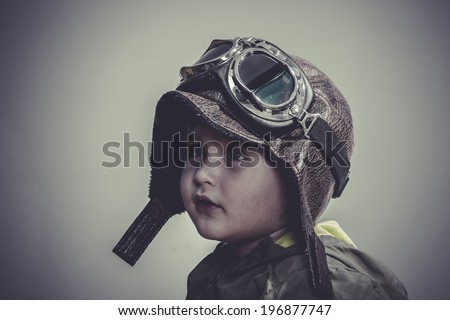 travel, fun and funny child dressed in aviator hat and goggles