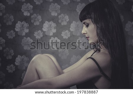 Lonely, sensual brunette woman, sad emotion over vintage background