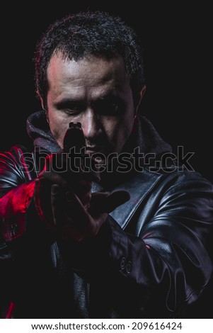 risk, thief with gun in hand. man in leather jacket