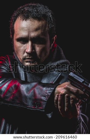 danger, thief with gun in hand. man in leather jacket